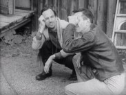 Ingmar Bergman och Gunnar Fischer under inspelningen av Ansiktet, båda sitter på huk.