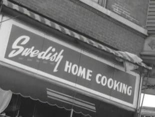 En restaurangskylt med texten "Swedish Home Cooking".